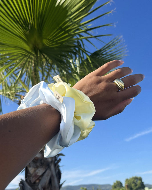 two silk scrunchies on a wrist