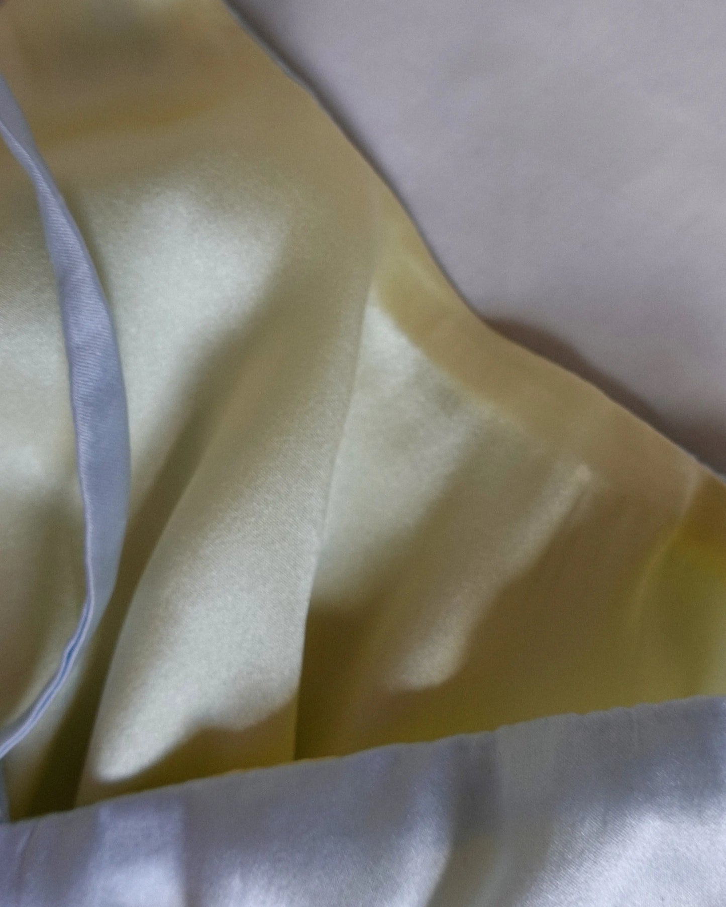 close-up on silk reversible bralette, blue side and yellow side