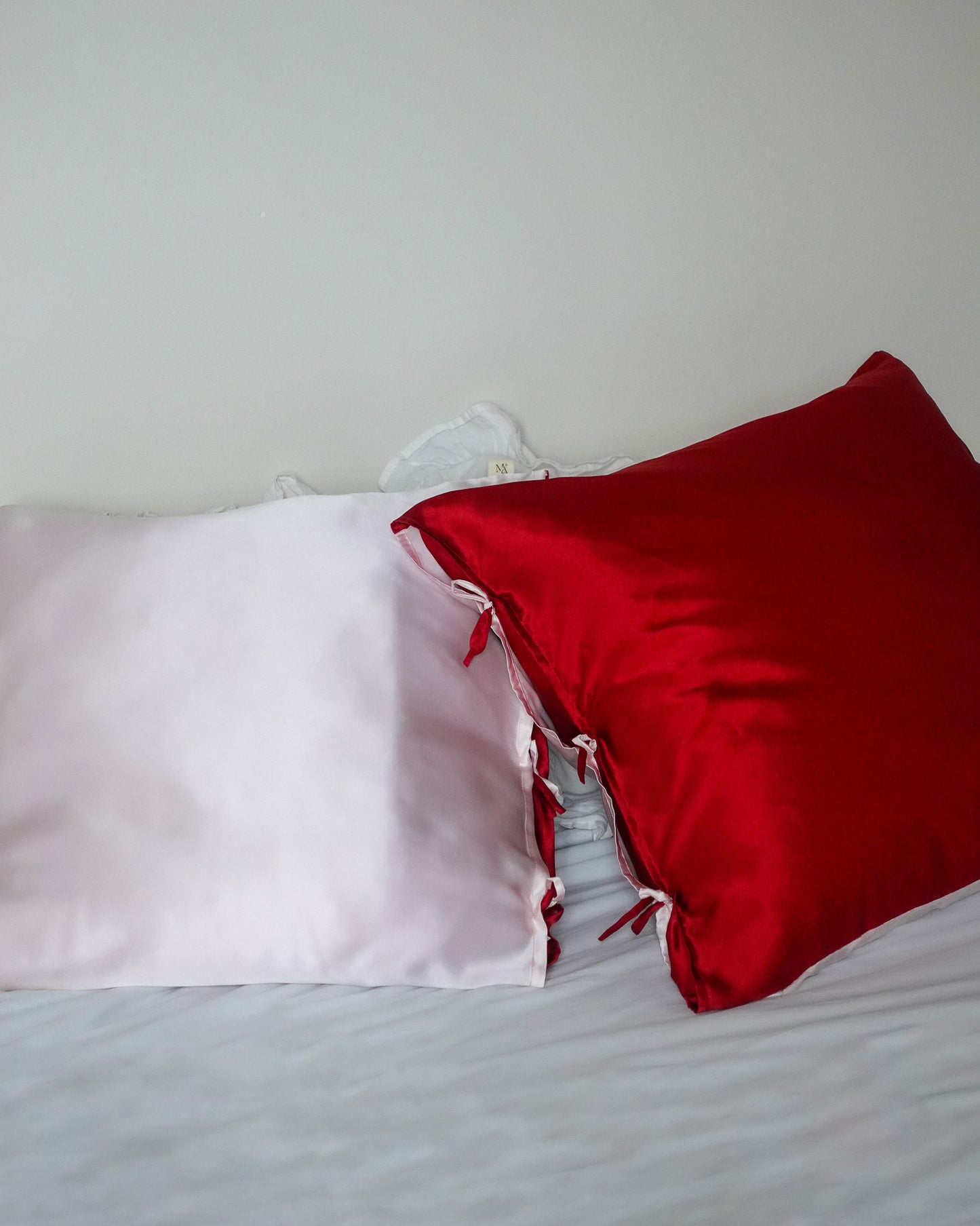 two mulberry silk pillowcases red and pink on a bed