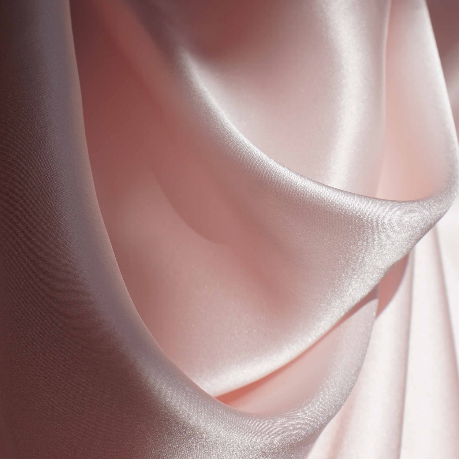 Close-up of pink silk fabric with a soft texture