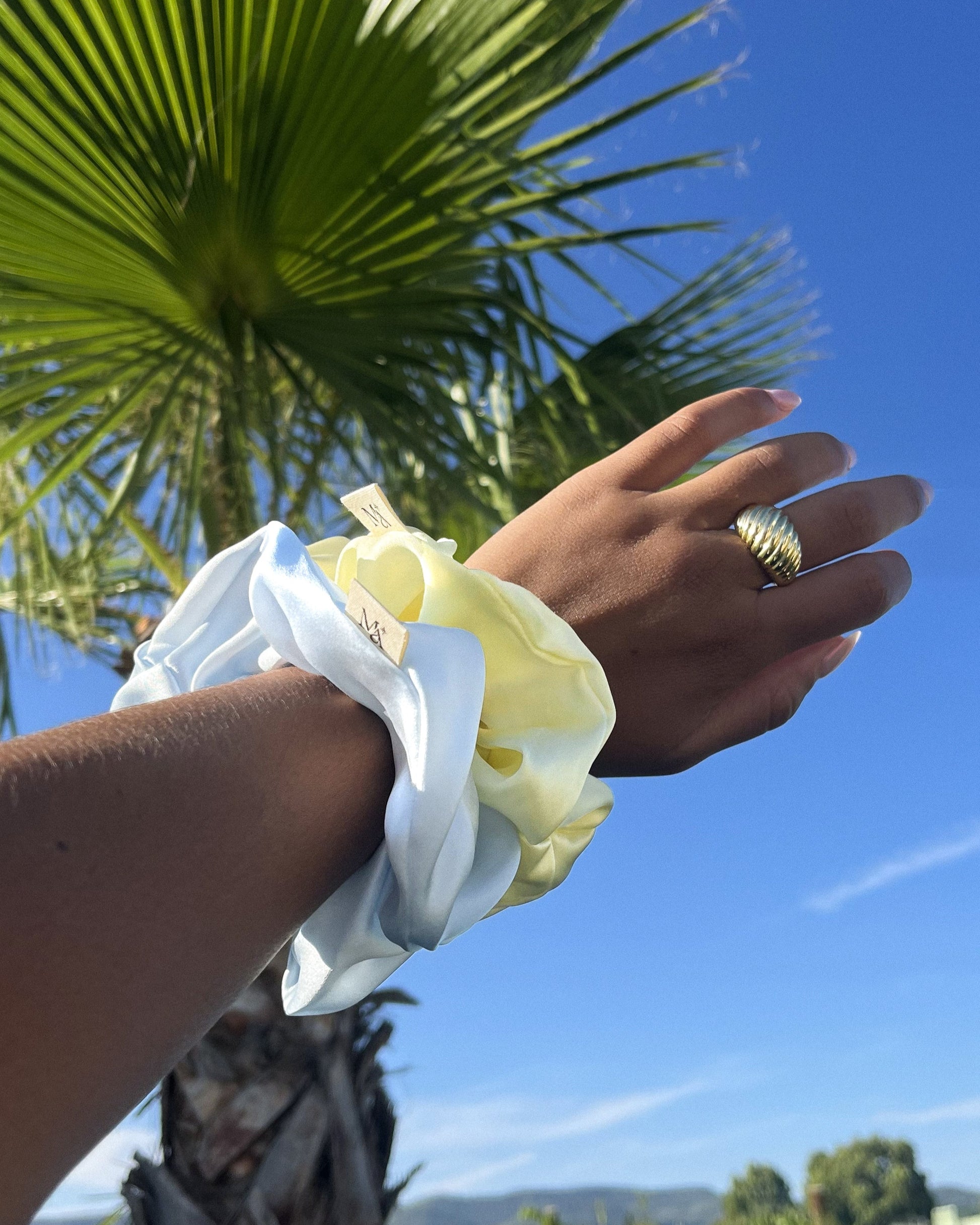 two silk scrunchies on a wrist