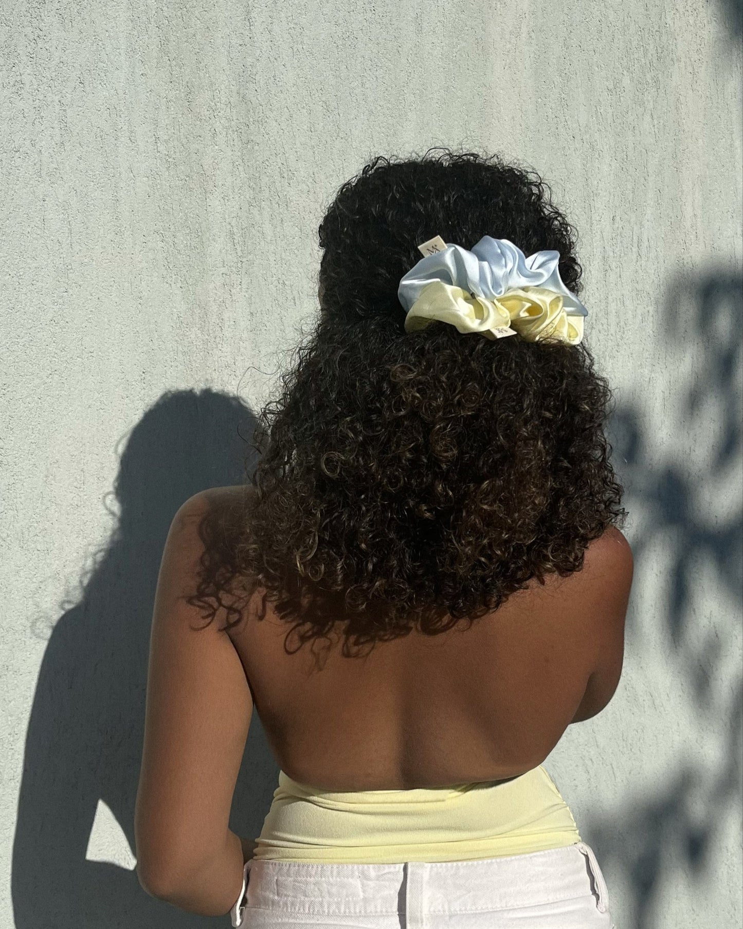 woman wearing the silk scrunchies duo in her hair