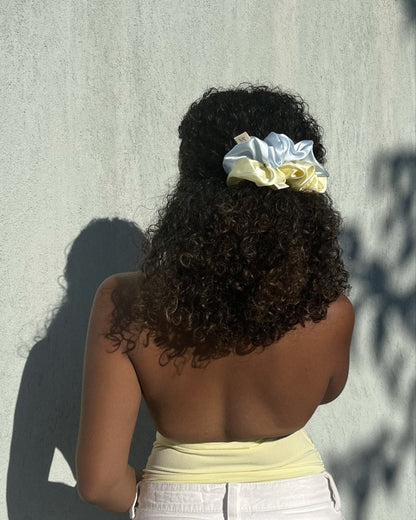 woman wearing the silk scrunchies duo in her hair