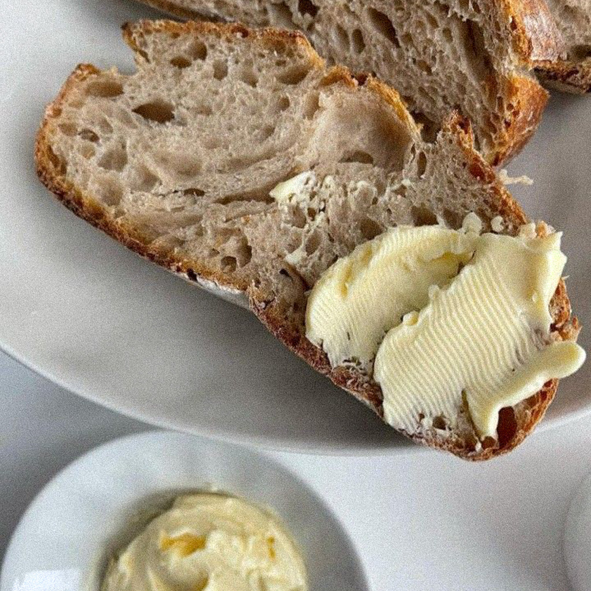 Fresh butter on warm bread with a little bit of salt.
