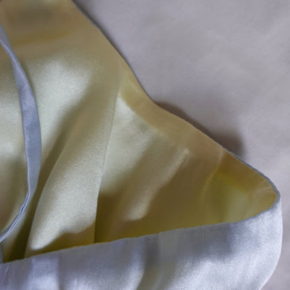 close-up on silk reversible bralette, blue side and yellow side