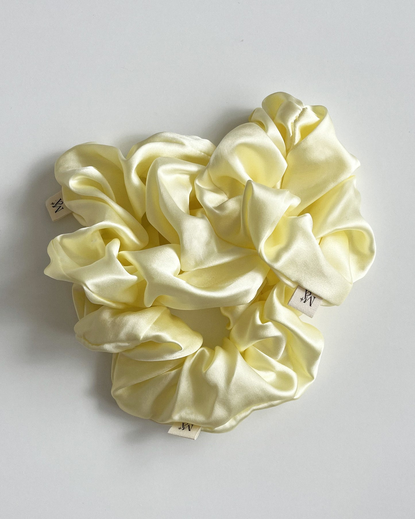yellow silk scrunchies on white background